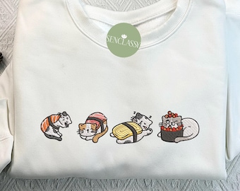 May include: White sweatshirt with a graphic of four cats dressed as sushi. The cats are wearing different types of sushi, including nigiri, maki, and sashimi. The text "Senclassi" is printed on the sweatshirt.