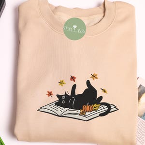 Cat Lying On Book With Fall Leaves Embroidered Sweatshirt, Cat Lover Gift, Reading Sweater, Halloween Black Cat, Autumn Gifts, Bookish Shirt