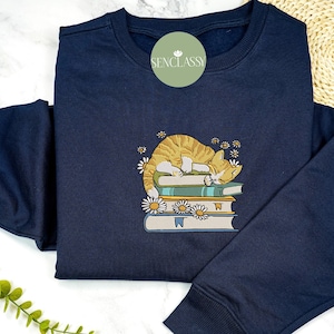 Cat Laying On The Book Embroidered Sweatshirt, Daisy Flower Cat Book Shirt, Bookish Sweater, Book Lover Gift, Cat Lover, Book Worm Shirt