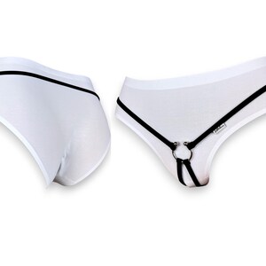 May include: White underwear with black straps and a silver ring. The straps are adjustable and can be worn in different ways.