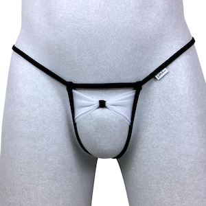 May include: Black and white lingerie with a bow detail. The lingerie has a small tag that says "Silkhem".