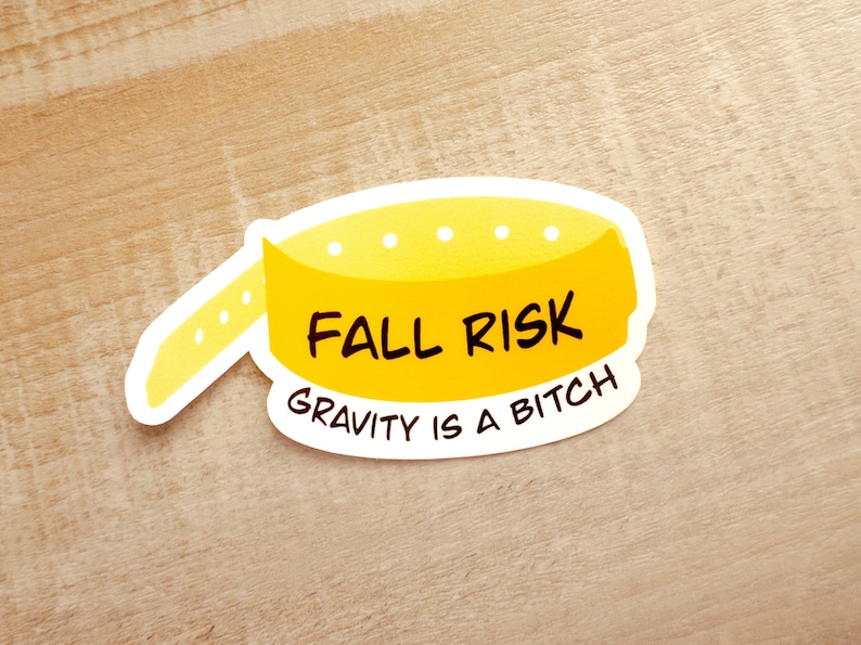 May include: Yellow sticker with the text "Fall Risk" and "Gravity is a Bitch" in black lettering.