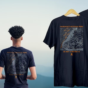 Black t-shirt featuring a minimalist topographic contour map of Haleakala volcano on Maui, Hawaii, in white line art. Unisex national park hiking tee.