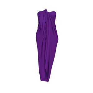 May include: A vibrant purple sarong, draped and knotted, creating a strapless dress silhouette. The fabric is gathered at the top and falls in soft folds, showcasing a flowing design. The garment is displayed against a plain white background.