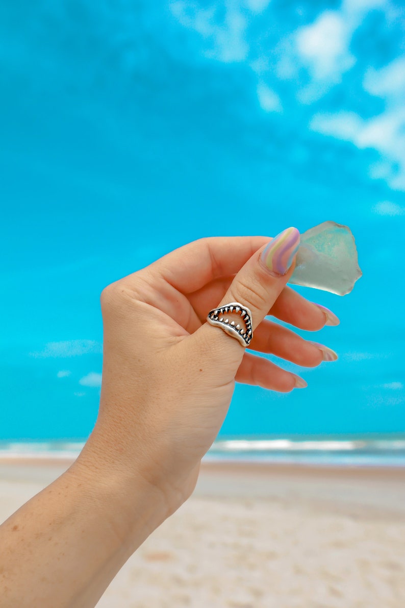 Shark Jaw Ring on a hand holding sea glass
