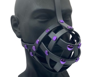 May include: Black leather muzzle with a cage design and purple heart-shaped studs.