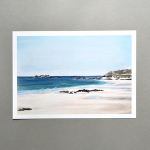 May include: Watercolour painting of a beach scene under a light blue sky. The ocean is a deep blue with white waves on a white sandy beach. A small island with a lighthouse is in the distance.