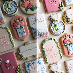 May include: Assortment of decorated sugar cookies for a bridal shower. The cookies feature floral designs, a ring, a lemon tree, and the text "Bride to Be" and "Victoria's Bridal Shower".