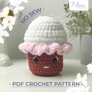 May include: Crochet pattern for a no-sew cupcake amigurumi toy. The cupcake is brown with pink icing and a white top. The pattern is available as a PDF download.