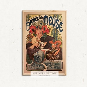 May include: A vintage poster advertising "Bières de la Meuse" featuring a woman in a floral hat holding a glass of beer. The poster is in a wooden frame and has a red, white, and blue colour scheme.