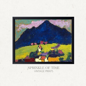 May include: A vintage abstract painting of a mountain landscape with a blue mountain, green fields, and pink and yellow houses. The painting is framed in black.