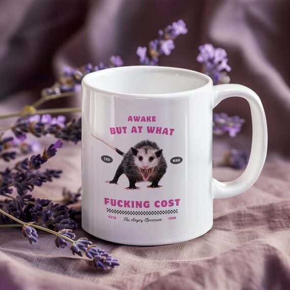 Angry Opossum Awake, But At What Fucking Cost 11oz Ceramic Double Sided Mug with Pink Text and Screaming Opossum Design