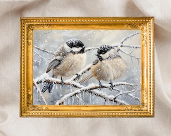 May include: A gold-framed painting depicting two small birds with black caps and pale brown plumage, perched on snow-laden branches. The artwork is set against a neutral backdrop, with a decorative gold frame.