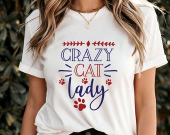 May include: White t-shirt with blue and red text that reads "Crazy Cat Lady" with paw prints.