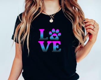 May include: A black t-shirt with a pink, blue and purple gradient design that says "LOVE" with a paw print in the middle of the "O".