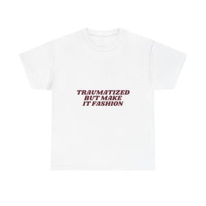 May include: A white short-sleeved t-shirt featuring the text "TRAUMATIZED BUT MAKE IT FASHION" printed in a dark maroon, sans-serif font across the center of the chest. The garment has a crew neckline and a standard, relaxed fit silhouette.