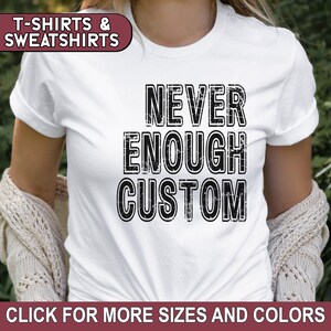 May include: White t-shirt with black text that reads "NEVER ENOUGH CUSTOM".