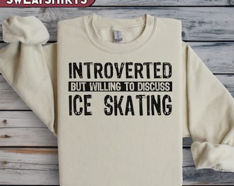 May include: A beige sweatshirt with black text that reads "Introverted but willing to discuss ice skating".