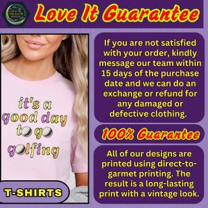 May include: A light pink t-shirt with the text "it's a good day to go golfing" in colorful lettering and golf ball graphics. The shirt also has the word "T-SHIRTS" at the bottom. The image includes a guarantee.