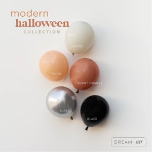 May include: Five balloons in different colors: stone, teddy, burnt orange, silver, and black. The balloons are arranged in a circle on a white background. The text "modern halloween collection" is at the top of the image. The text "DREAM + air" is at the bottom of the image.