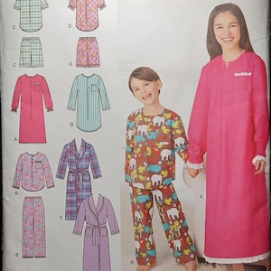 May include: A sewing pattern for children's pajamas. The pattern includes a long-sleeved nightgown, a robe, and a pajama set with a long-sleeved top and pants. The pattern is for sizes 3-6. The pattern is from Simplicity and is designed by Karen Z.