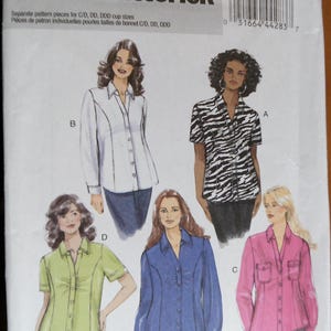 May include: Butterick B5721 sewing pattern for women's blouses. The pattern includes multiple blouse designs with various sleeve lengths and styles. The pattern is for sizes 26W-32W and includes separate pattern pieces for C/D, DD, and DDD cup sizes.