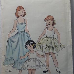 May include: Vintage Butterick printed patterns for girls' dresses. The illustration shows three girls in different dresses, including a long blue dress, a yellow skirt, and a white dress. The pattern includes the size, breast measurement, and price.