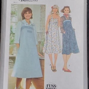 May include: Simplicity 8466 sewing pattern featuring three dress designs. The pattern includes a light blue dress with a collar and pockets, a floral print dress, and a denim-style dress. The pattern is size 8 and includes special instructions for fitting.