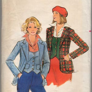 May include: Vintage Butterick sewing pattern featuring illustrations of two women's outfits. One woman wears a blue blazer, vest, and pants. The other wears a plaid jacket, green vest, and red skirt. The pattern is size 12.