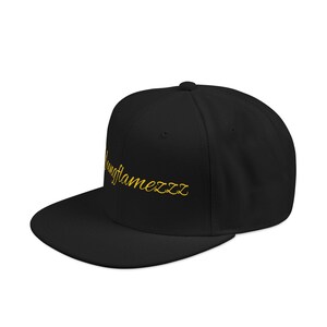 May include: Black flat-brimmed baseball cap with the gold text "ungflamezzz" embroidered on the front. The cap has a structured crown and a flat visor. The hat is a classic style.