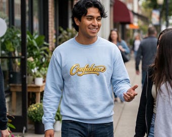 Sudadera unisex con el lema "Confidence Script" / Letras doradas retro, cuello redondo motivacional. Varios colores disponibles. Envío rápido. Estilo grandioso.