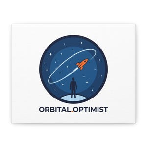 May include: A canvas print featuring a circular design with a rocket ship in orbit around a planet. A silhouetted figure stands below, with the words "ORBITAL OPTIMIST" printed at the bottom. The background is a dark blue with white stars.