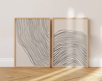 Puede incluir: Dos impresiones de arte abstracto enmarcadas con dibujos de líneas en blanco y negro sobre un fondo beige. Las impresiones están en marcos de madera y están colgadas en una pared blanca.