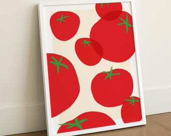 Op de afbeelding: Een ingelijste kunstprint met een patroon van rode tomaten met groene stelen op een crèmekleurige achtergrond. De tomaten variëren in grootte en overlappen elkaar, wat een modern ontwerp creëert. De lijst is wit.