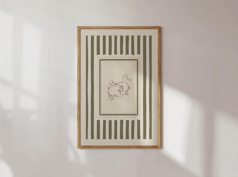 This vintage duck art print features two hand-drawn ducks among flowers, framed by soft sage stripes and a scalloped border. Ideal for cottagecore nurseries, farmhouse spaces, or elegant gallery walls, it adds gentle charm and a nature-inspired warmth to any room.
