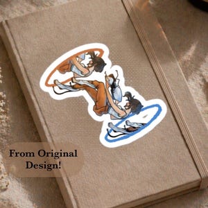 May include: A die-cut sticker featuring a character in a white tank top and brown pants falling through an orange portal and emerging from a blue portal. The character has dark hair and is depicted in a dynamic, mid-air pose with limbs extended.