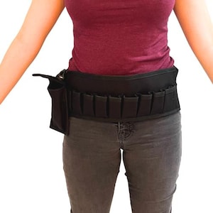 May include: A black gardening tool belt with multiple pockets and pouches. The belt is worn around the waist and has a sturdy design. It is made of a durable, dark material and is designed to hold various gardening tools.