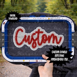 May include: A gray garment with a red and silver glitter "Custom" design is held in a blue embroidery hoop. The image includes text that says "Digital Download" and "Custom Double Applique Embroidery File."