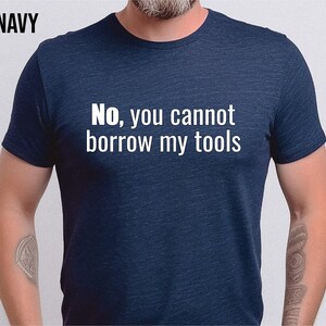 May include: A navy blue t-shirt with the text "No, you cannot borrow my tools" printed in white.
