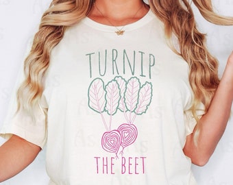 May include: A white t-shirt with a graphic of a turnip and a beet with the text "Turnip the Beet".