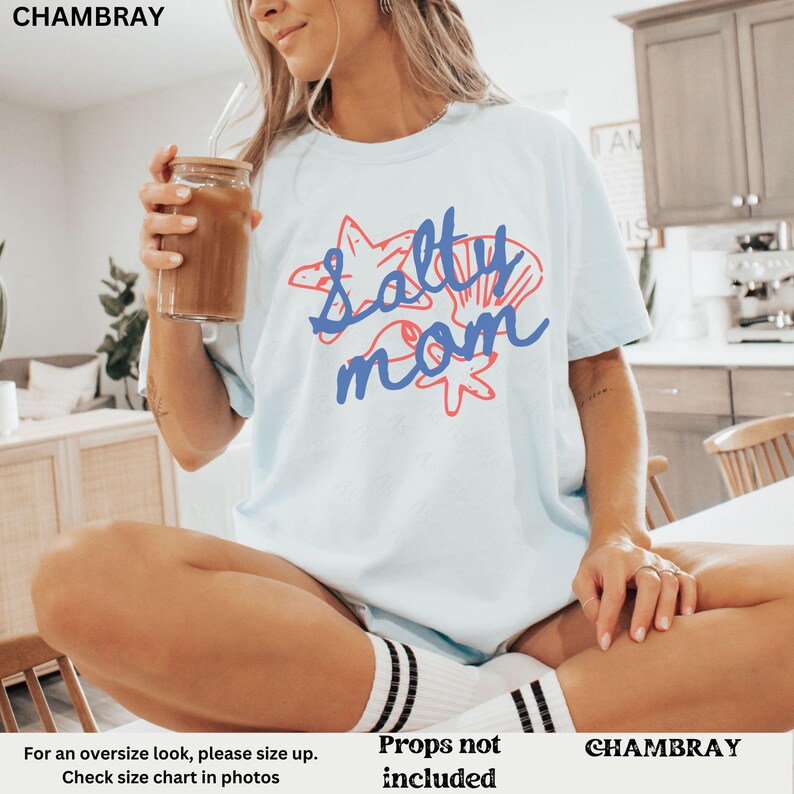 May include: A light blue t-shirt with the text "Salty Mom" in blue and red lettering. The text is surrounded by a starfish and seashells.