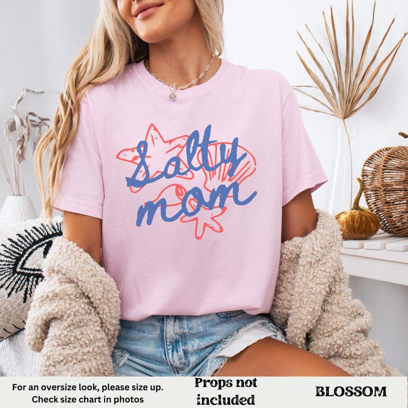 May include: Pink t-shirt with the text "Salty Mom" in blue and red. The text is surrounded by images of seashells and starfish.