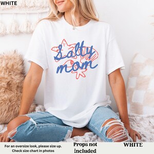 May include: White t-shirt with a blue and red graphic that says "Salty Mom" with a starfish and seashells.