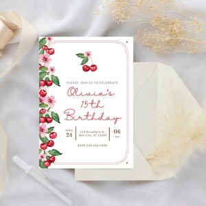May include: A white invitation with a red border and cherry blossom design. The text reads "Please join us to celebrate Olivia's 15th Birthday" with the date and time of the event.