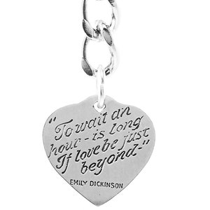 May include: Silver keychain with a heart-shaped charm that reads "To wait an hour - is long If love be just beyond" by Emily Dickinson.