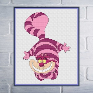 May include: A cross-stitch pattern of the Cheshire Cat from Alice in Wonderland. The cat is pink and purple with a wide grin and a mischievous expression.