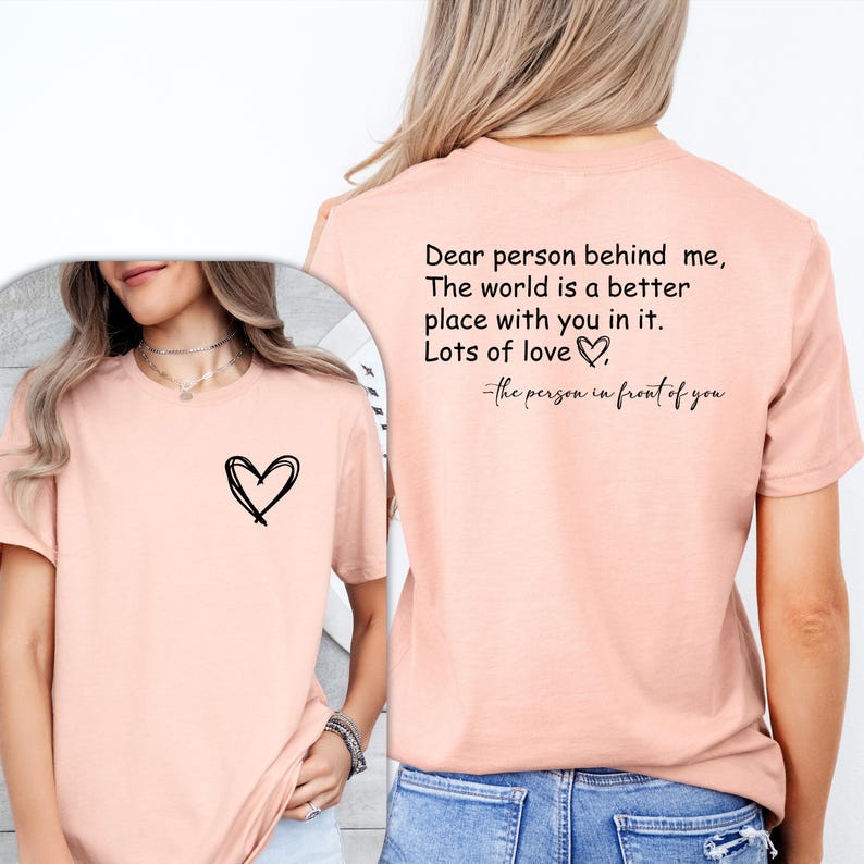 a woman wearing a pink shirt with a heart on it