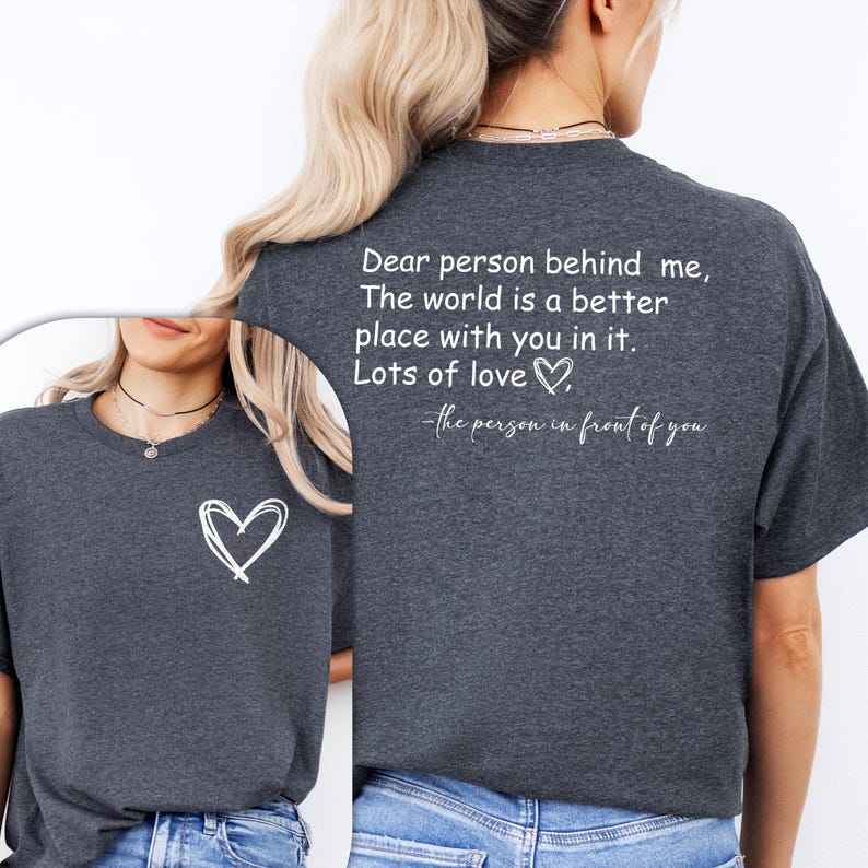 a woman wearing a t - shirt that says dear person behind me the world is