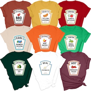 May include: A collection of t-shirts in various colors, each featuring a sauce label design. The labels include "BBQ Sauce," "Yellow Mustard," "Tomato Ketchup," "Ranch Dressing," "Hot Sauce," "Basil Pesto," "Guacamole Dip," "Mayonnaise," and "Sriracha Sauce."