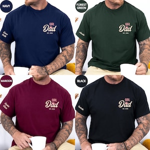 The image is a collage of four different t-shirt designs, each featuring a man with tattoos. The t-shirts are in various colors, including navy blue, green, maroon, and black. The designs include the text "GIRL Dad" and "EST. 2006" on the t-shirts, indicating that the t-shirts are personalized to celebrate the relationship between a father and his daughter.
